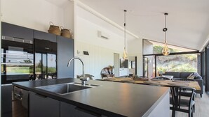 A modern kitchen with a large island, built-in appliances, and pendant lighting. - "Kristiina" - 500m from the sea by Interhome (Saltum)