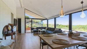 A modern interior with a dining area, sofas, and a view of the outdoors. - "Kristiina" - 500m from the sea by Interhome (Saltum)