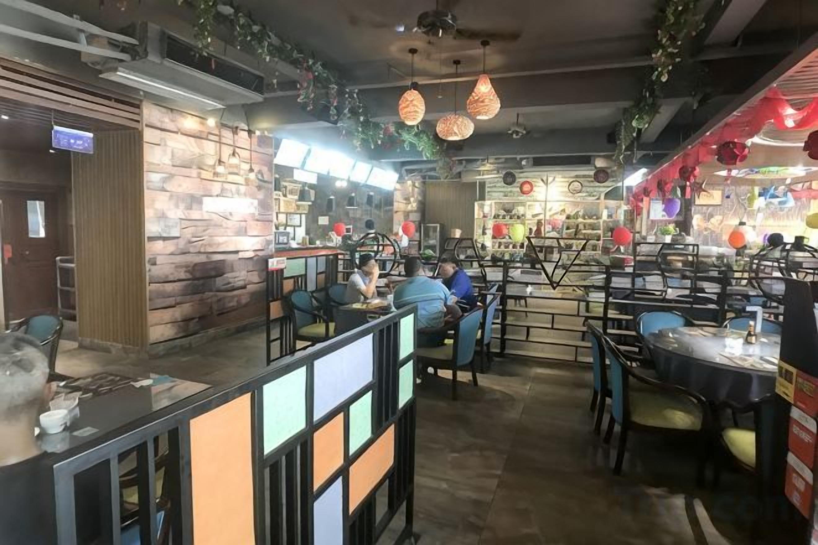 A restaurant interior with a bar area, seating arrangements, and a counter.