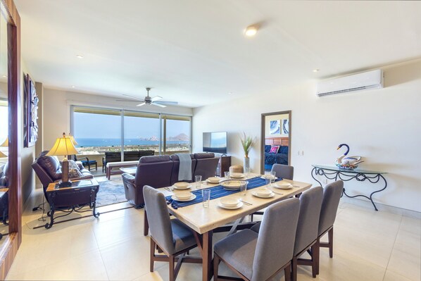 A dining area with a table set for four, a sofa, and a view of the city.