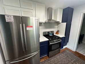 A kitchen with a stainless steel refrigerator, a stove, and a built-in oven. - Spacious 4BR/2BA Home Near FSU, Capitol & Hospital (Tallahassee)