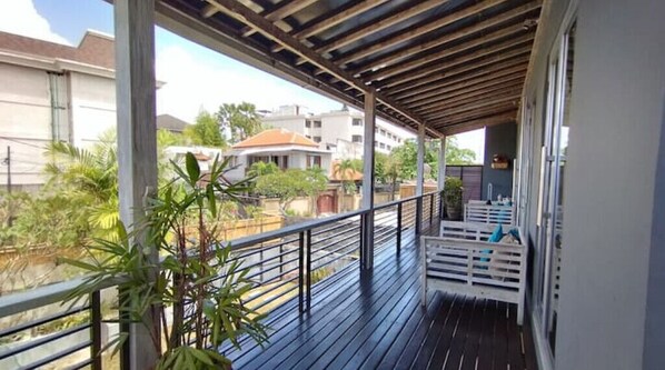 Enjoy the serene views of the surrounding neighborhood from this balcony.