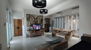 Relax in style with a comfortable seating area featuring a flat-screen TV and a large window with an outside view.