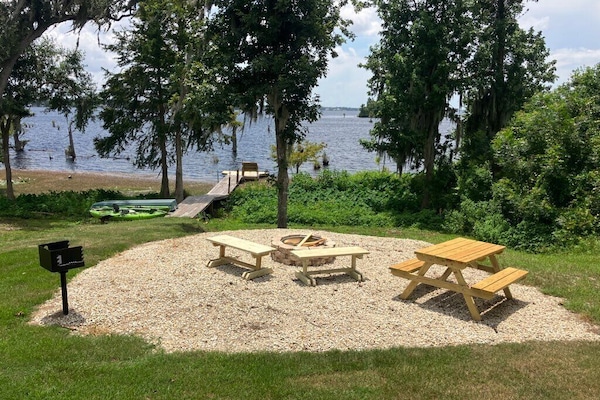 View from the front porch. Charcoal grille and firepit by the lake