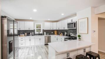 Fridge, coffee/tea maker, highchair, cookware/dishes/utensils