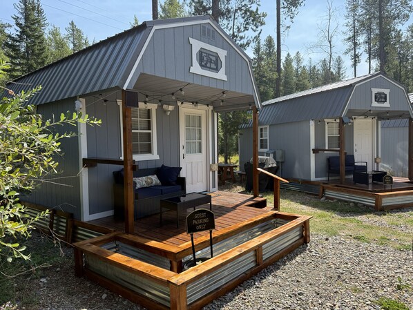 A guest parking area with a wooden deck and a sign indicating it is for guests only.
