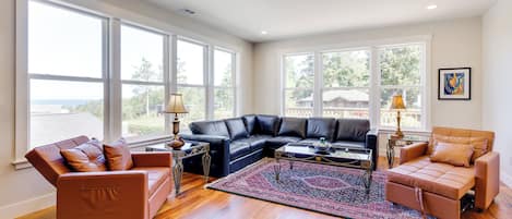 A spacious living room with a sectional sofa, a coffee table, and a patterned rug.