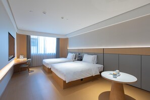 A hotel room with two beds, a desk, a chair, a round table, and a large window with curtains. - Ji Hotel Hangzhou Jiaogong Road (Hangzhou)