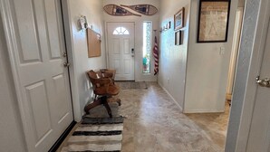 A hallway with a dining table and chairs, a rug, and an American flag. - Javelina House - Lake Montezuma (Lake Montezuma)
