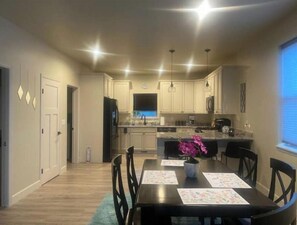 Enjoy meals in this kitchen with a central island, oven, and dining table.