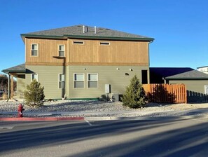 Stylish two-story home with a modern design, featuring a flat roof and multiple windows for ample natural light.