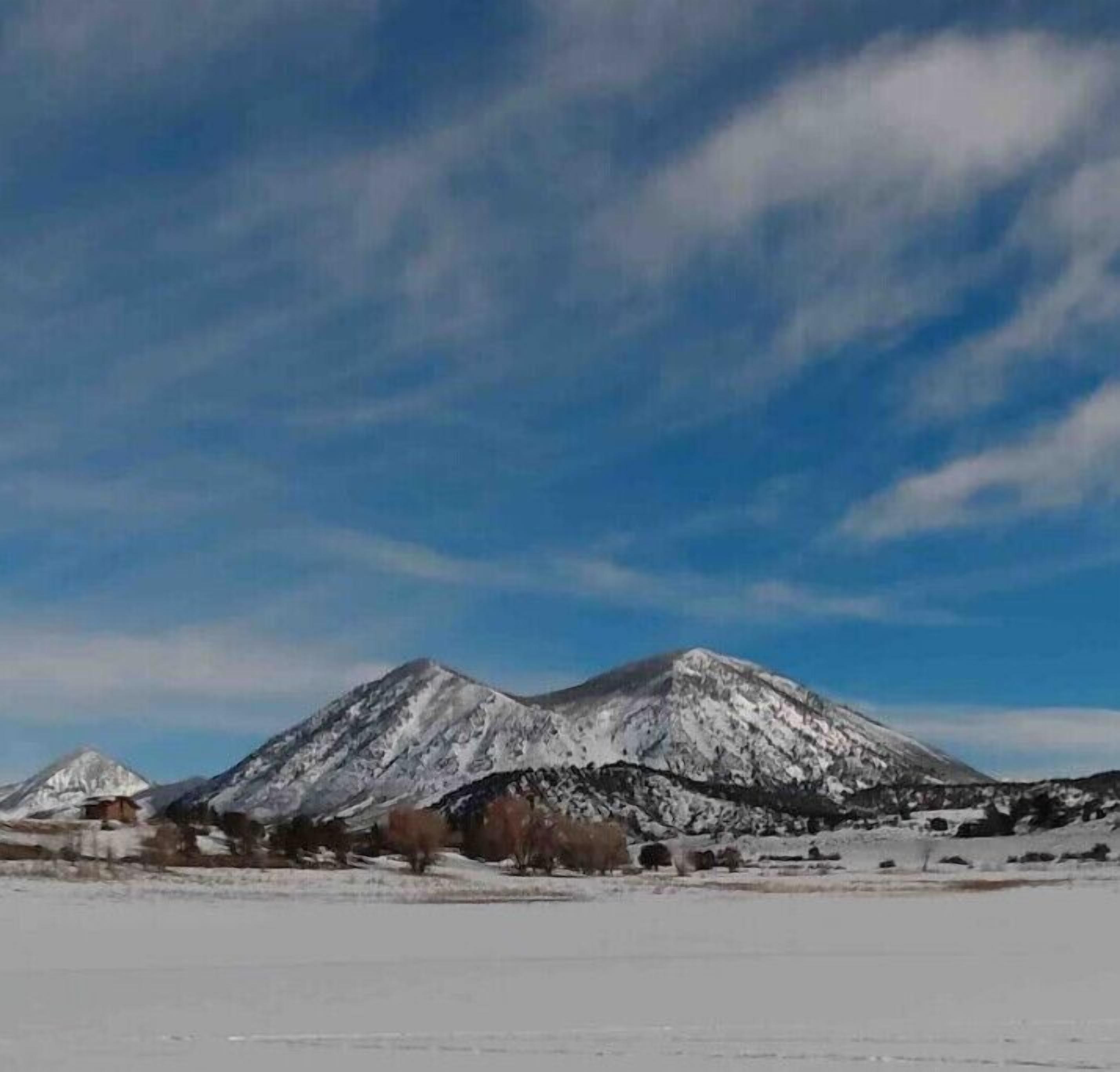 A snow-covered mountain landscape with a clear sky.