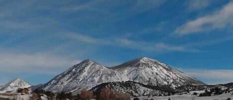 A snow-covered mountain landscape with a clear sky.