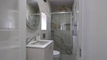 Shower, hair dryer, towels, toilet paper
