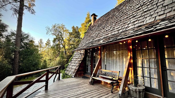 A cabin with a wooden deck, a bench, and a small porch area. - Clarity Cabin A-Frame Sanctuary w Hot Tub, Fireplace, Grill, AC, Hammock Chairs, Fire Pit, Pets OK (Idyllwild-Pine Cove)