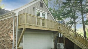 A two-story house with a wooden deck and a garage. - Cozy Sanctuary/Dwtn Franklin Studio w Priv Entry (Franklin)