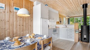 A modern kitchen with white cabinets, a built-in oven, and a black stove. - "Hira" - 300m from the sea by Interhome (Væggerløse)