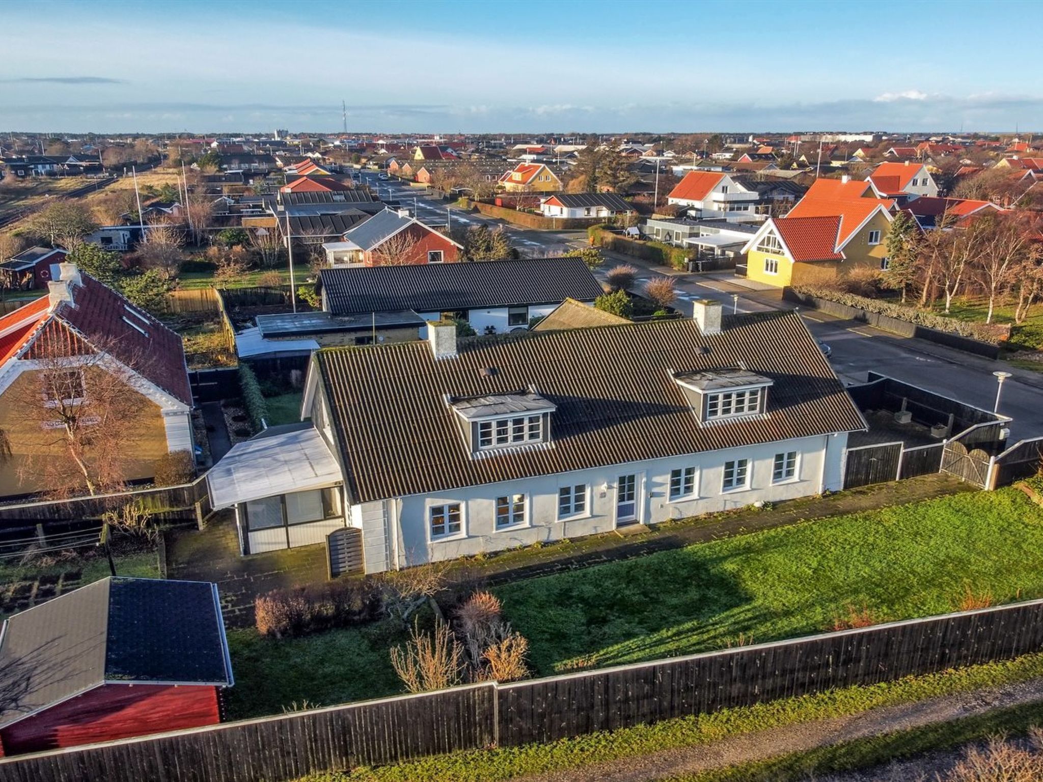 A residential area with houses featuring sloped roofs and a mix of architectural styles.