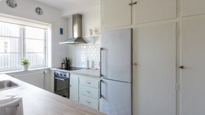 A modern kitchen with white cabinets, a stainless steel range hood, and a built-in oven. - "Borka" - 150m from the sea by Interhome (Skagen)