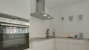 A modern kitchen with a Siemens oven, a coffee machine, and a built-in range hood. - "Janes" - 400m from the sea by Interhome (Skagen)