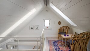 A high-ceilinged attic room with a sloped roof, a small window, and a view of the sky. - "Elle" - 50m from the sea by Interhome (Skagen)