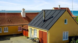 A yellow building with a red roof, a chimney, and a small window. - "Elle" - 50m from the sea by Interhome (Skagen)