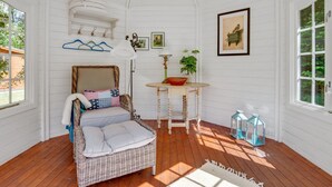 A cozy room with a wicker sofa, a small table with a lamp, and a hanging light fixture. - "Mirla" - 300m from the sea by Interhome (Læsø)