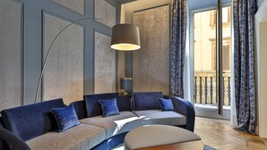 A modern living room with a sofa, a round coffee table, and a floor lamp.