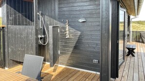 A wooden deck with a built-in shower and a chair. - "Hinda" - 1.2km from the sea by Interhome (Bindslev)