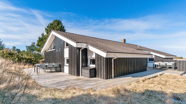 A modern beach house with a large deck, outdoor seating, and a covered area. - "Riika" - 425m from the sea by Interhome (Hirtshals)