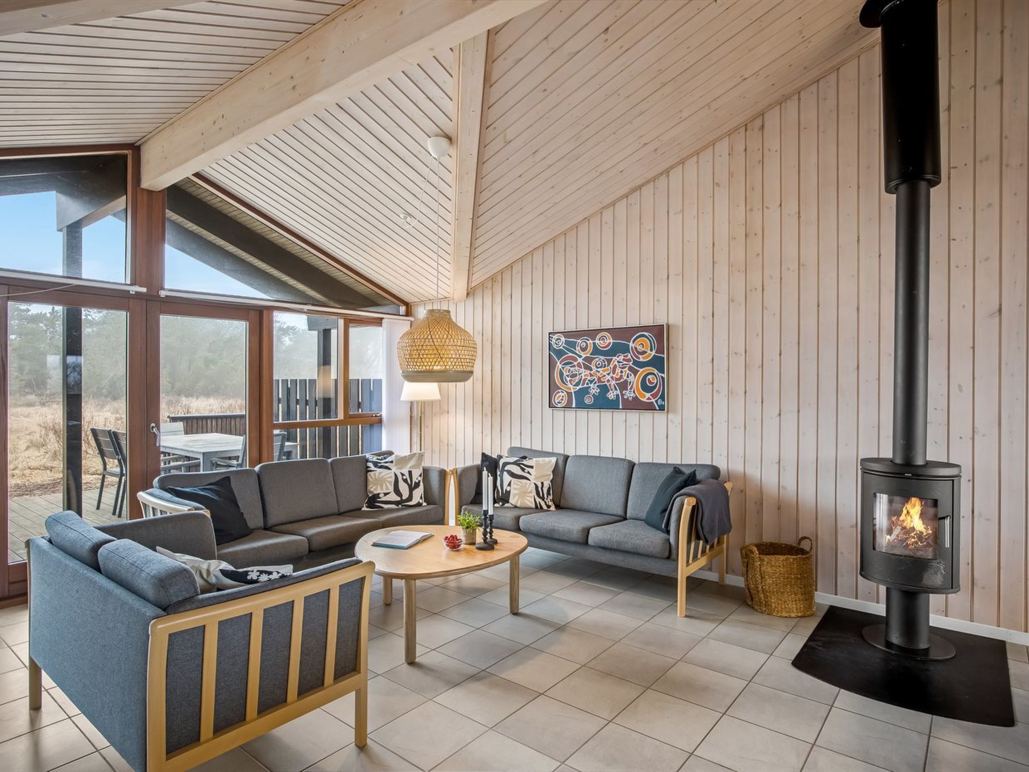 A cozy living room with a sofa set, a coffee table, and a fireplace.