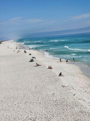 Guests can enjoy a serene beach experience with gentle waves and open space.