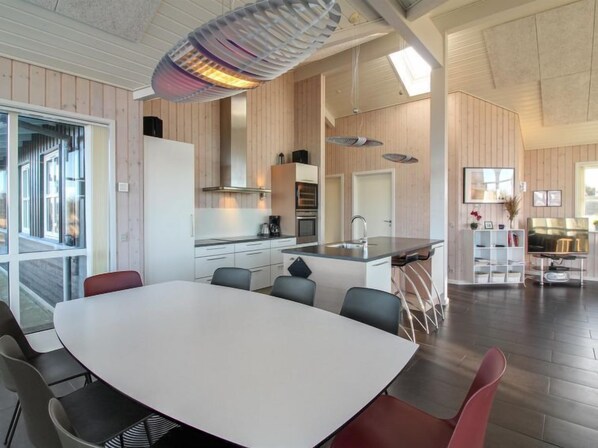 Enjoy cooking in this well-equipped kitchen with a central island, oven, and dining area.