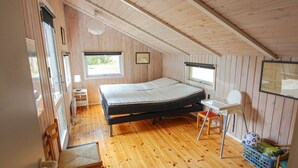 A small, wooden-paneled room with a bed, a desk, and a chair. - "Nakke" - 1.3km from the sea by Interhome (Hjørring)