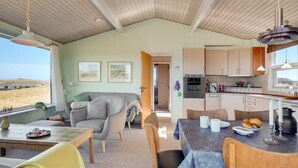 A cozy interior with a dining area, kitchen, and seating space.