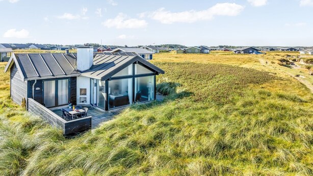 A modern house with a glass facade, situated on a grassy hill with a clear view of the surrounding area. - "Antonie" - 95m from the sea by Interhome (Hjørring)