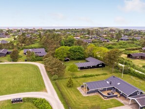 A residential area with houses, green lawns, and a clear sky. - "Fliri" - 700m from the sea by Interhome (Hjørring)