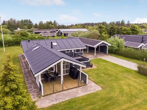 A residential complex with multiple houses featuring sloped roofs, a covered outdoor seating area, and a well-maintained lawn. - "Fliri" - 700m from the sea by Interhome (Hjørring)