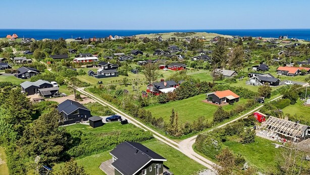 An aerial view of a residential area with houses, green lawns, and a clear view of the ocean. - "Freija" - 719m from the sea by Interhome (Hjørring)
