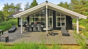 A modern house with a large deck, outdoor seating, and a barbecue grill. - "Arlett" - 950m from the sea by Interhome (Fjerritslev)
