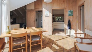 A modern wooden interior with a dining area, kitchen, and a large skylight. - "Roulf" - 1.1km from the sea by Interhome (Fjerritslev)