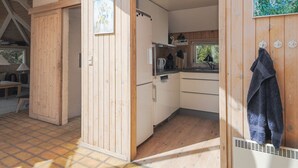A compact kitchen with wooden walls, a sink, and a window. - "Roulf" - 1.1km from the sea by Interhome (Fjerritslev)