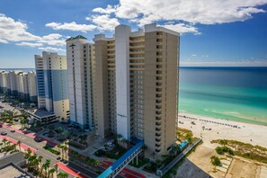 A high-rise hotel with multiple balconies overlooking a beach. - Salty Sundaze Beachfront King Master 2 Bed 2 Bath Sleeps 6+ Beach Service (Panama City Beach)
