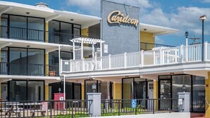 A two-story building with a balcony and a sign that reads "Carideon." - Settle In the Sun!
Fantastic centrally located North Wildwood Condo  (North Wildwood)