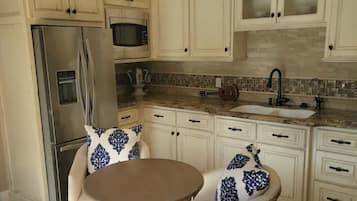 Fridge, microwave, coffee/tea maker, cookware/dishes/utensils