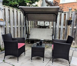 A patio with wicker furniture, a table, and a canopy. - Modern Cozy Luxury Suite in Ajax | 5 Min to Hwy 401 | Kitchen/ Laundry/Parking  (Ajax)