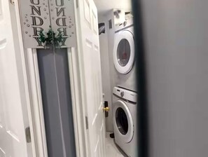 A laundry room with a door marked 'Laundry' and two washing machines. - Modern Cozy Luxury Suite in Ajax | 5 Min to Hwy 401 | Kitchen/ Laundry/Parking  (Ajax)