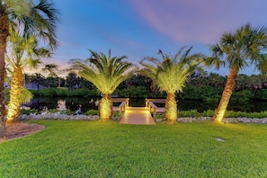 Stroll across the bridge to a serene oasis, surrounded by lush greenery and tranquil water.