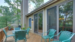A wooden deck with outdoor furniture and a sliding glass door leading to a covered patio area. - < 1 Mi to Camelback Resort: Home w/ Pool Table! (Tannersville)