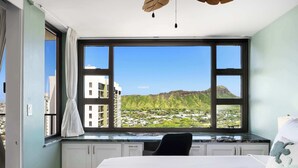 A bedroom with a large window, a bed, and a view of a cityscape and mountains. - 36FL Diamond Head & Ocean view condo w/ parking (Honolulu)